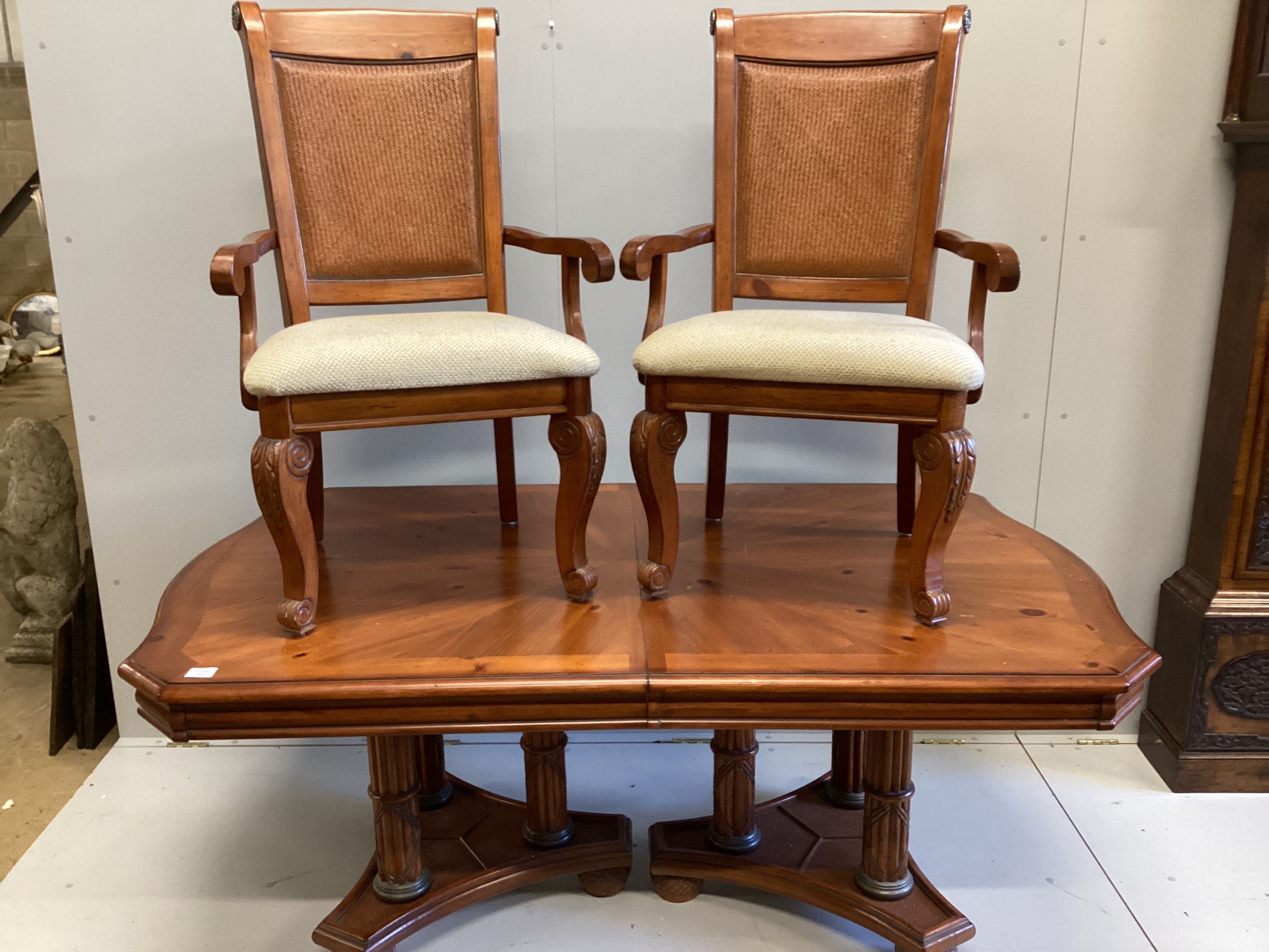 A reproduction cherry wood extending dining table, length 176cm, width 110cm, height 75cm and six chairs, two with arms